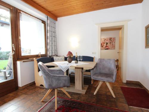 a dining room with a table and chairs at Apartment Tyrol-1 by Interhome in Aschau