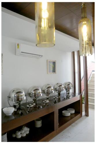 a room with a bunch of bowls on a shelf at Airport Hotel The R Blues - New Delhi in New Delhi