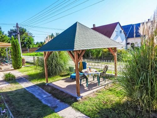 a gazebo with a roof in a yard at Holiday Home Sunny Day by Interhome in Balatonmáriafürdő