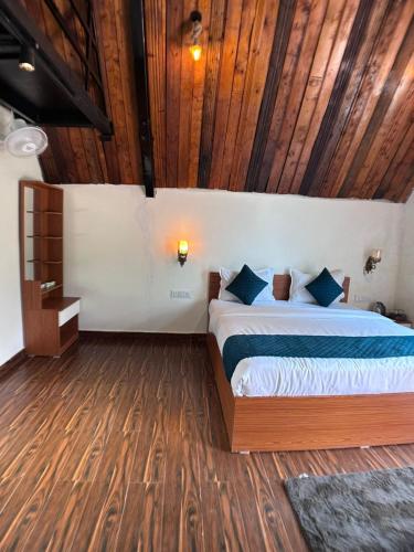 a bedroom with a bed and a wooden ceiling at A1 Tiger Resort in Kolāra