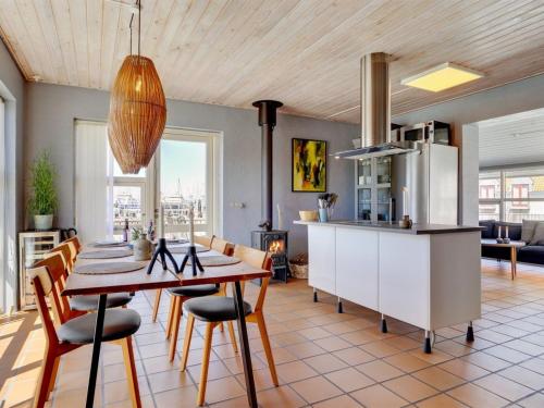 a kitchen and dining room with a table and chairs at Holiday Home Ljubinko - 50m from the sea by Interhome in Læsø