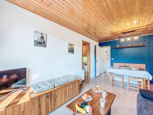a living room with a couch and a table at Apartment Pegase Phenix-74 by Interhome in Le Corbier