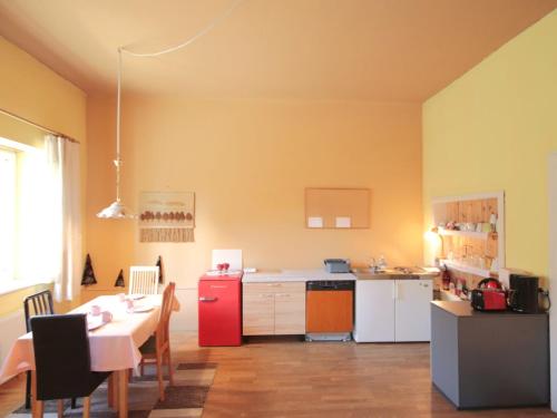 a kitchen with a table and a red refrigerator at Studio Ysella by Interhome in Raiding