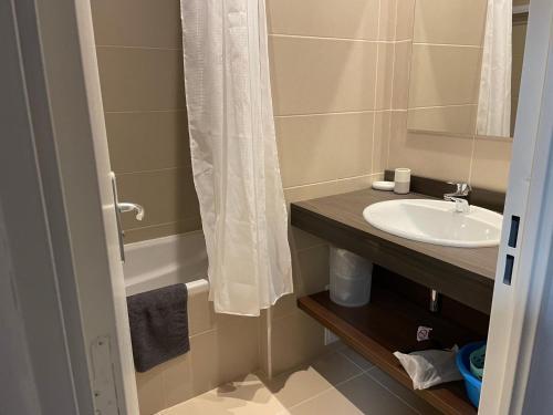 a bathroom with a sink and a shower curtain at Gourette - Studio cosy avec terrasse pour 4 pers - FR-1-860-51 in Gourette