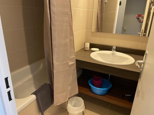 a bathroom with a sink and a bath tub next to a mirror at Studio 6 pers, piscine, animaux, Gourette - FR-1-860-37 in Gourette