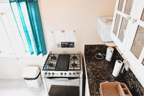 a kitchen with a stove and a counter top at Ocean Heights in Arnos Vale
