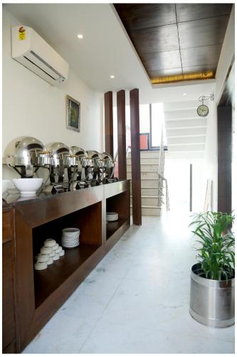 a kitchen with a bunch of pots and pans at Airport Hotel The R Blues - New Delhi in New Delhi