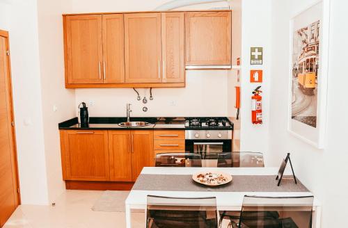 a kitchen with wooden cabinets and a counter top at Giestal Terrace By Gt House in Lisbon