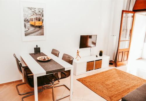 a dining room with a white table and chairs at Giestal Terrace By Gt House in Lisbon