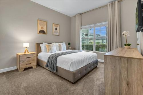 a bedroom with a large bed and a window at 4 Bedrooms 3 Bathrooms Storey Lake 3195 Pp in Orlando