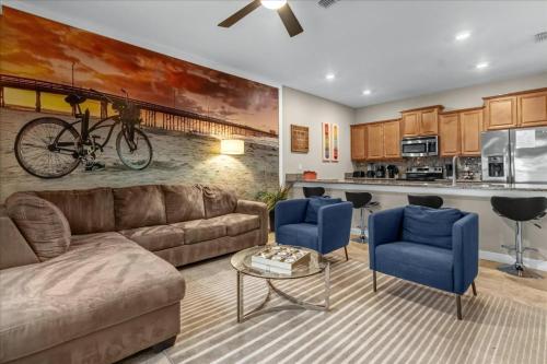 a living room with a couch and blue chairs at 4 Bedrooms 3 Bathrooms Storey Lake 3195 Pp in Orlando