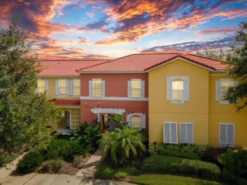 a house with a sunset in the background at 3 Bedrooms 25 Bathrooms Encantada 3091 Yl in Orlando