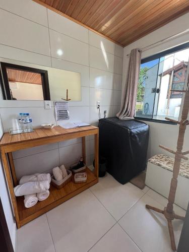 a bathroom with a desk and a mirror at Pousada Jardim in Lauro Müller