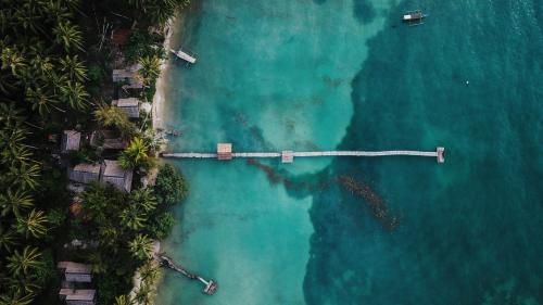 an aerial view of a bridge over the ocean at Poki Poki - Togian Islands in Bomba