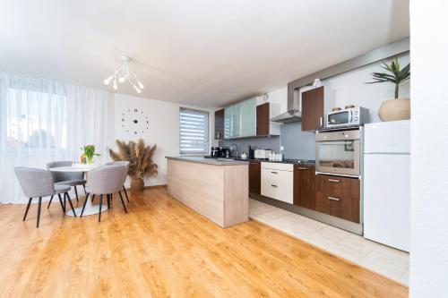 a kitchen with a table and a dining room at D Apartments Čadca Centrum in Čadca