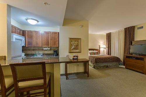 a hotel room with a kitchen and a bedroom at Staybridge Suites Harrisburg-Hershey by IHG in Harrisburg