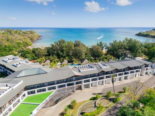 an aerial view of a building with the ocean in the background at Ocean's Creek Beach Hotel in Balaclava