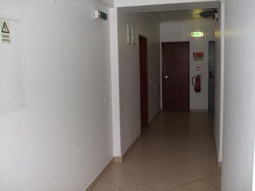 an empty hallway of a building with a fire hydrant at Hotel Adelaide in Faro