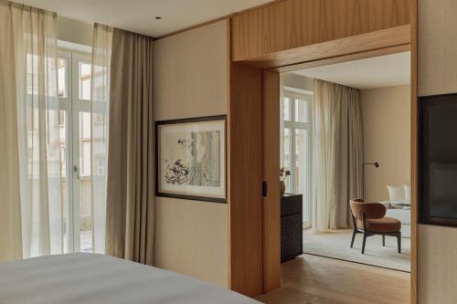 a bedroom with a bed and a sliding glass door at The Florentin by Althoff Collection in Frankfurt/Main