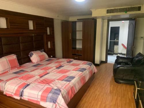 Ένα ή περισσότερα κρεβάτια σε δωμάτιο στο Chibuzor Apartment