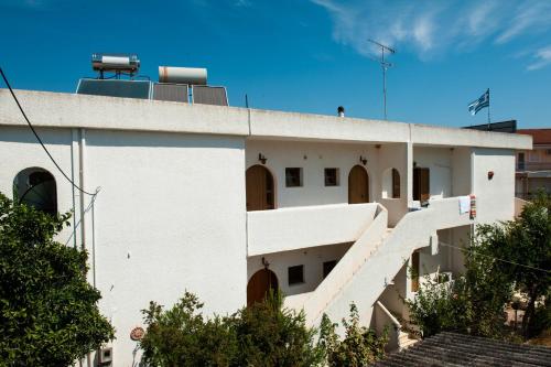 a white building with stairs on the side of it at Studios Margarita in Petalidhion