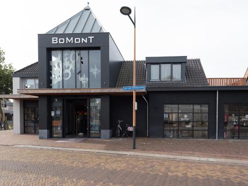 a black building with a sign that reads benoit at Luxury apartment in Renesse with infrared sauna in Renesse