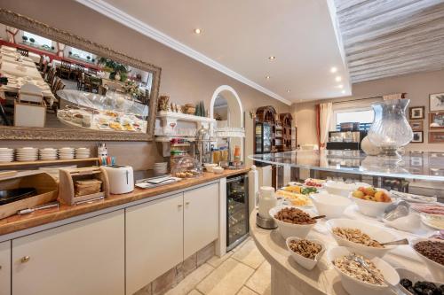 a buffet line with bowls of food on display at Hotel Garni Keil in Kleinarl
