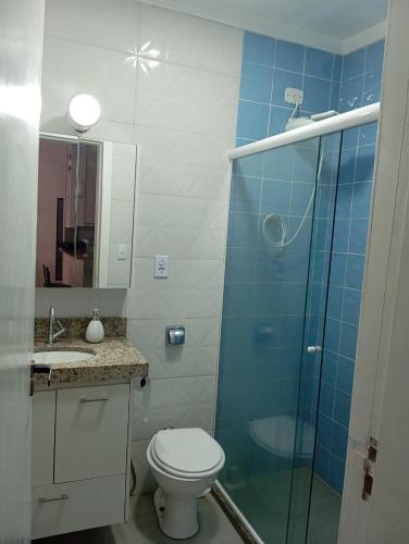 a bathroom with a toilet and a glass shower at Beira-mar in Santos
