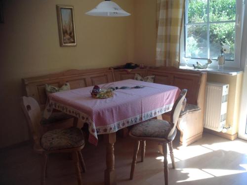 a dining room table with a pink and white table cloth at Ferienwohnung Haus Anja In Bad Füssing in Bad Füssing