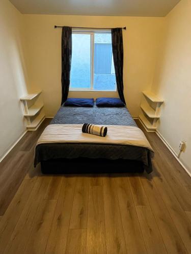 a bedroom with a large bed with a window at Van Nuys Homes for the Soul in Los Angeles