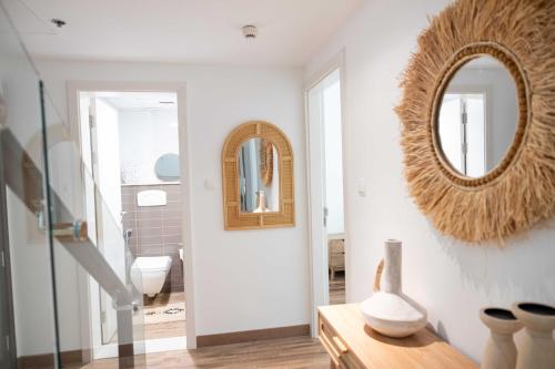 a bathroom with a mirror on the wall at Tula Thaara Duplex with Private Beach and Pool in Al Marjan Island in Ras al Khaimah