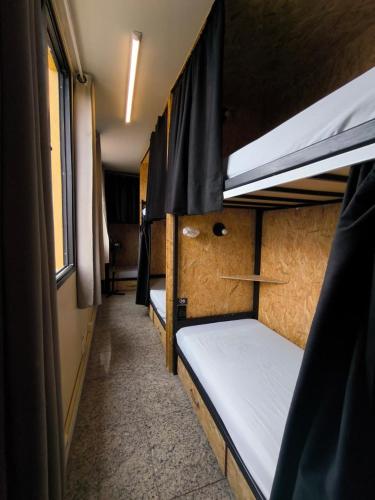 a room with two bunk beds in a dorm room at MEC Office Hostel in Niterói