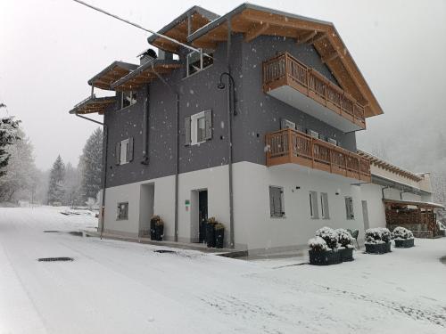 a large building with snow on the ground at Casa Nadia - Val di Sole Apartment in Piano