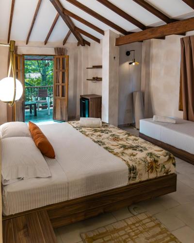 a bedroom with two beds in a room at Palma Serena Finca Hotel in Santa Fe de Antioquia