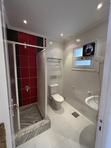 a bathroom with a shower and a toilet and a sink at Herrmes in Sharm El Sheikh