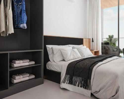 a bedroom with a large bed with towels on it at Muro Alto em Porto de Galinhas Apto Alto Padrão in Ipojuca