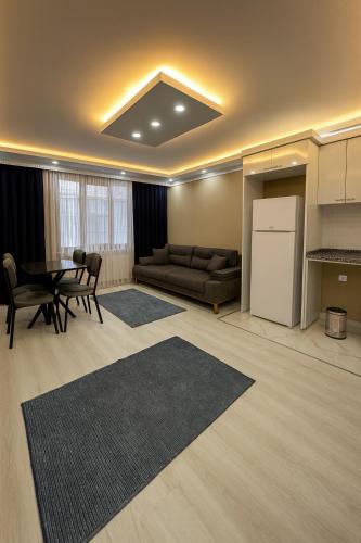 a kitchen and a living room with a table and a couch at Loft House Studio in Arnavutköy
