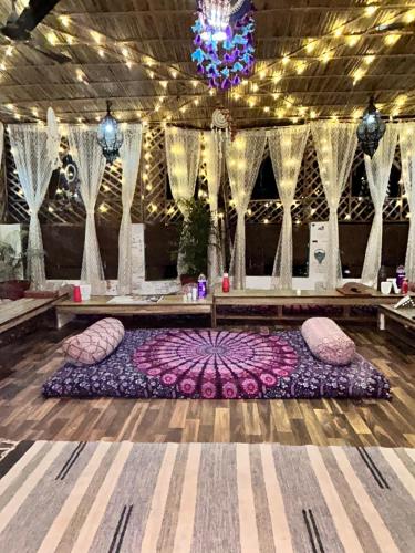 a room with pillows on the floor with a table at Flamingos Hostel Jaipur in Jaipur