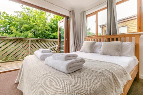 a bedroom with a bed with towels on it at Landal Leycroft Valley in Perranzabuloe
