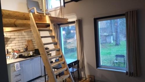 eine Küche mit Hochbett in einem Tiny House in der Unterkunft Waterfront Residence in Ladziņas