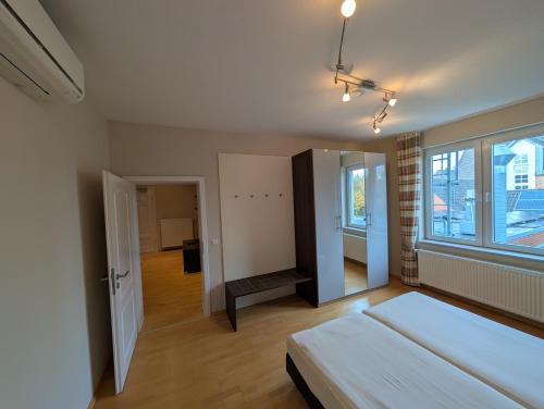 a bedroom with a bed and a large window at Hotel Tenbrock - Restaurant 1905 in Gescher