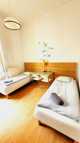 a bedroom with a bed and a desk and a table at Central Station Hostel in Warsaw