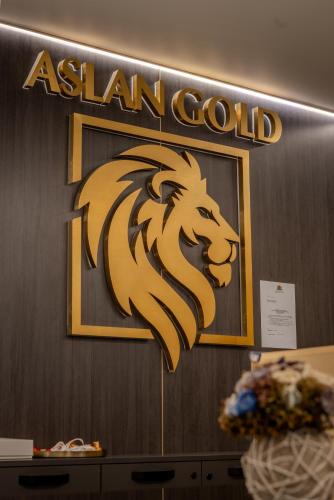 a nigerian gold sign on a wall at Aslan Gold Hotel in Varna City