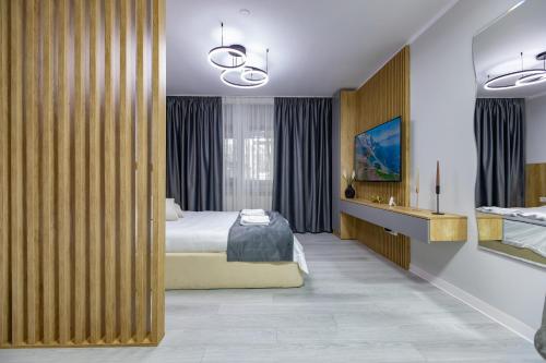 a hotel room with a bed and a bathroom at Zoris Apart1 in Bacău