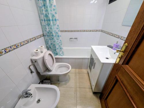 a bathroom with a toilet and a sink at VV 68 Secretario Artiles in Las Palmas de Gran Canaria