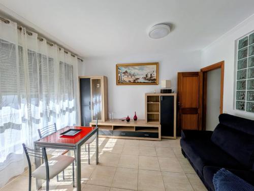 a living room with a table and a couch at VV 68 Secretario Artiles in Las Palmas de Gran Canaria