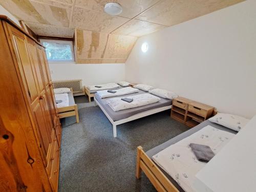 a room with three beds in a room at Chata JedlOvka in Jiřetín pod Jedlovou