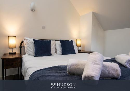 a bedroom with a large bed with two pillows at Home with Rear Terrace in Ironbridge in Ironbridge
