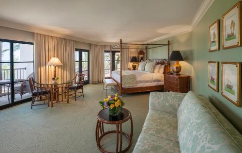 a bedroom with a bed and a table with a couch at Santa Barbara Inn in Santa Barbara