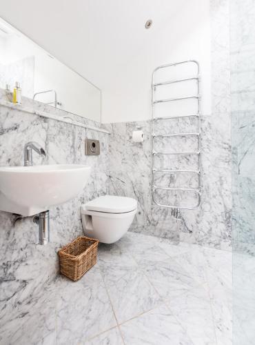 a white bathroom with a sink and a toilet at Seaview Penthouse 2 in Alnmouth